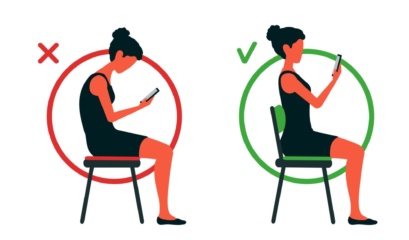 Woman Looking At Her Phone Reading A Physiotherapist’s Guide To Kyphosis