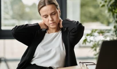 Middle Aged,woman,with,neck,pain,,stressed,,sitting,in,front,of