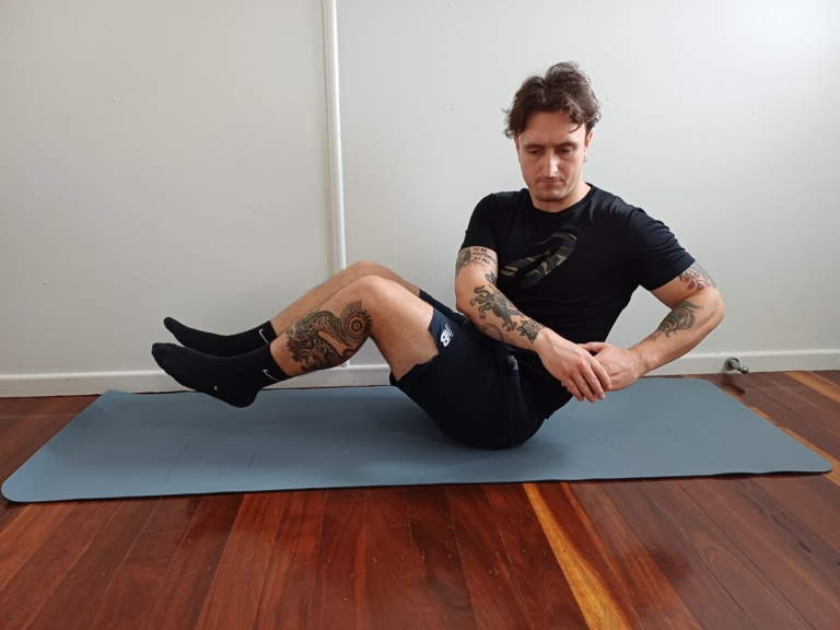 Man Performing The Russian Twist